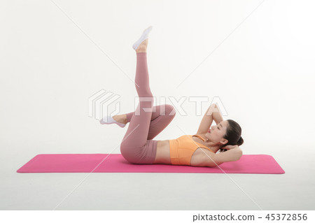 A Korean woman doing yoga exercise on mat 45372856