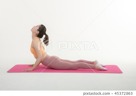 A Korean woman doing yoga exercise on mat A Korean woman doing yoga exercise on mat 45372863