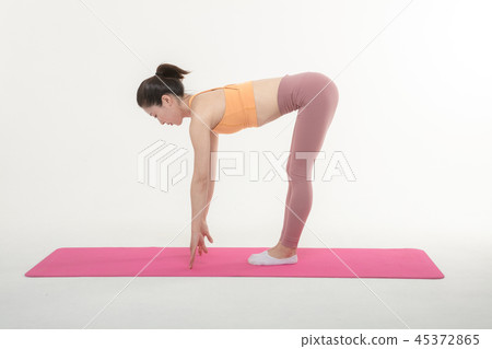 A Korean woman doing yoga exercise on mat A Korean woman doing yoga exercise on mat 45372865