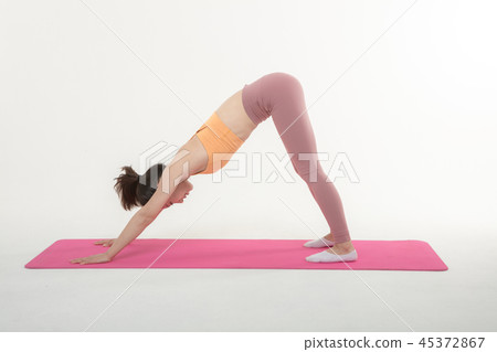 A Korean woman doing yoga exercise on mat A Korean woman doing yoga exercise on mat 45372867