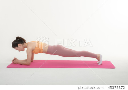 A Korean woman doing yoga exercise on mat A Korean woman doing yoga exercise on mat 45372872