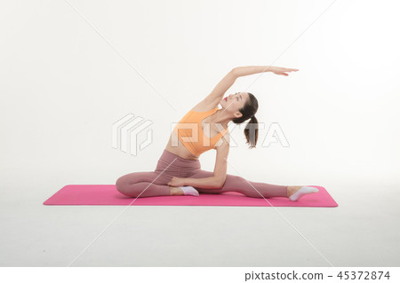 A Korean woman doing yoga exercise on mat A Korean woman doing yoga exercise on mat 45372874