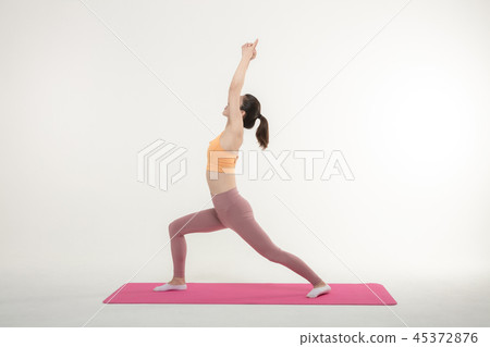 A Korean woman doing yoga exercise on mat A Korean woman doing yoga exercise on mat 45372876