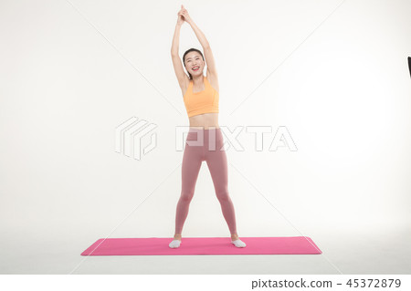 A Korean woman doing yoga exercise on mat A Korean woman doing yoga exercise on mat 45372879