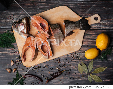 trout cut into pieces on wooden Board on table. Fresh raw red fish 45374598