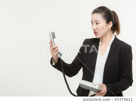 A career woman makes while talking on the phone A career woman makes while talking on the phone 45374621