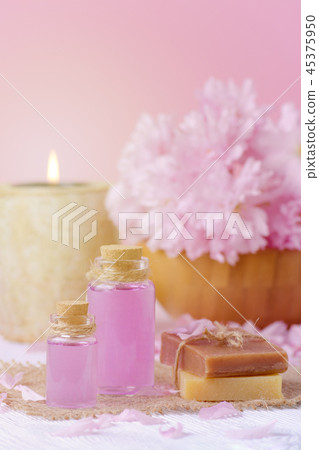 beautiful spa composition with massage oil, candle, soap bar and fresh pink flowers beautiful spa composition with massage oil, candle, soap bar and fresh pink flowers 45375950