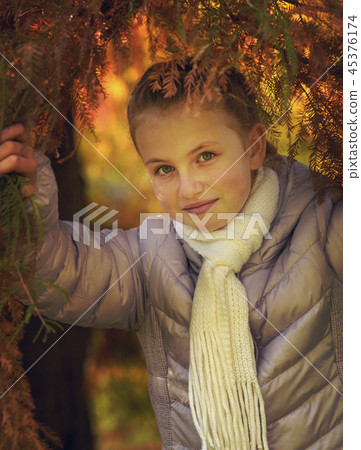 Happy girl laughing and playing in autumn leaves Happy girl laughing and playing in autumn leaves 45376174