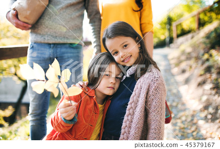 A young family with children walking in park in autumn. 45379167