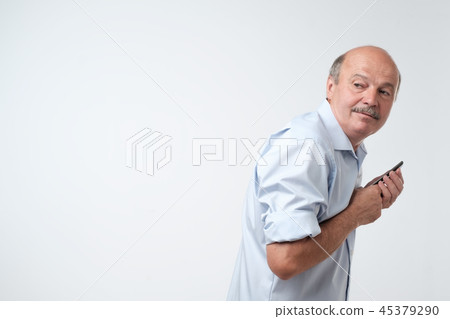 man reading sms on his phone man reading sms on his phone 45379290