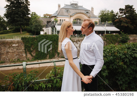 Attrective couple dance on the embanlment. Green background. Active pastime Attrective couple dance on the embanlment. Green background. Active pastime 45380198