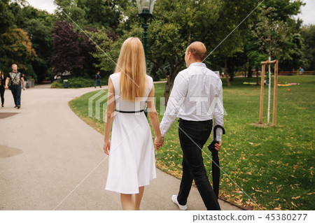 Young couple walking in the park. The have fun and rejoice. Black and white clothes 45380277