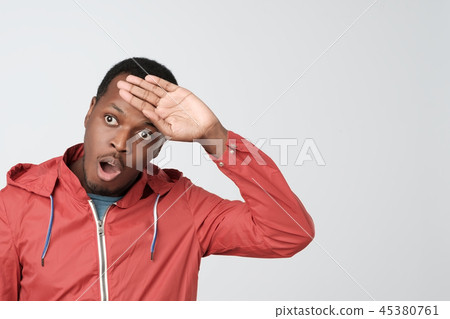 Man in red jacket, whiping sweat out of forehead. Man in red jacket, whiping sweat out of forehead. 45380761