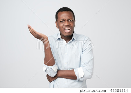 African young man dissatisfied frowns 45381314