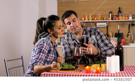 Happy loving couple is having romantic dinner at home. 45381507