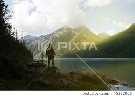 Silhouette male tourist against mountains. Silhouette male tourist against mountains. 45382006