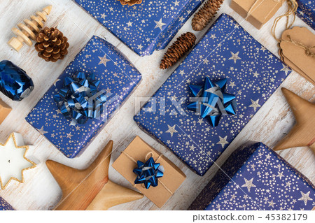 Presents in blue wrapping paper on table 45382179