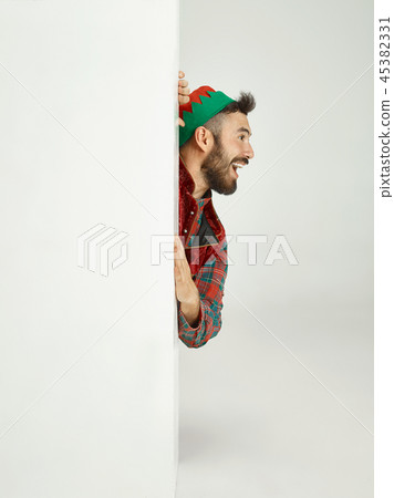 friendly man dressed like a funny gnome posing on an isolated gray background 45382331