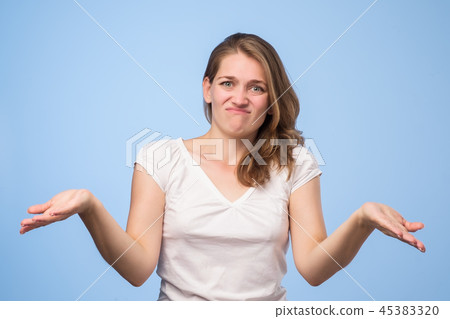 Shrugging european woman in doubt doing shrug 45383320