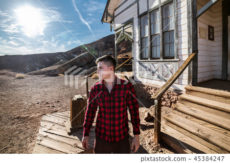 Farmer countryside man standing in front of house 45384247