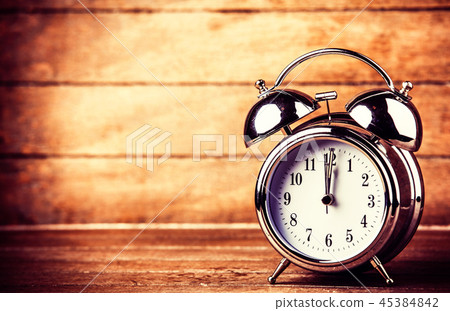 gray metal alarm clock on a wooden table gray metal alarm clock on a wooden table 45384842