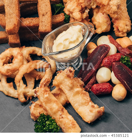 set of snacks for beer from crackers, onion rings, sausage and cheese set of snacks for beer from crackers, onion rings, sausage and cheese 45385121