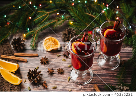 Christmas mulled wine with orange, spices on a wooden table Christmas mulled wine with orange, spices on a wooden table 45385221