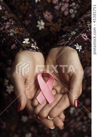 young woman with a pink ribbon in her hands. 45385751