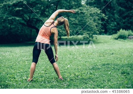 woman exercising on nature forest lawn 45386065