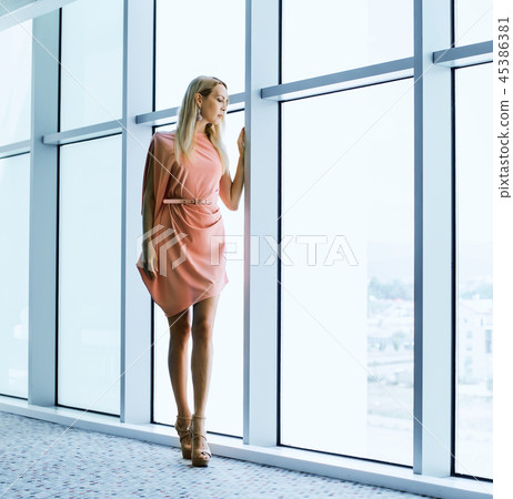 stylish woman near window in the office building stylish woman near window in the office building 45386381