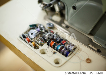 a set of colored thread for a sewing machine. 45386601