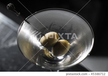Dry Martini cocktail on a bar desk. black background Dry Martini cocktail on a bar desk. black background 45386712