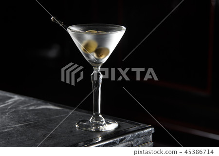 Dry Martini cocktail on a bar desk. black background Dry Martini cocktail on a bar desk. black background 45386714