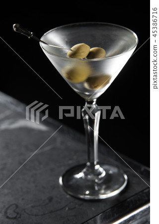 Dry Martini cocktail on a bar desk. black background Dry Martini cocktail on a bar desk. black background 45386716