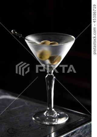 Dry Martini cocktail on a bar desk. black background Dry Martini cocktail on a bar desk. black background 45386719