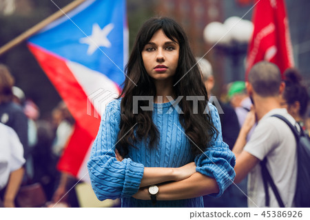Beautiful activist woman protesting on city street 45386926