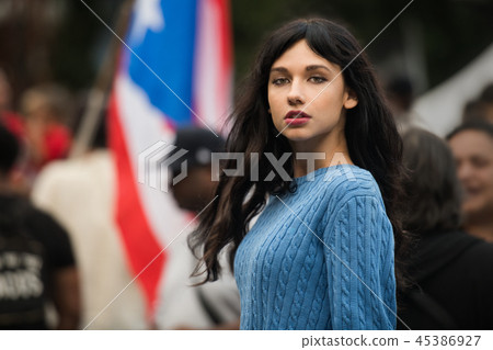 Beautiful activist woman protesting on city street Beautiful activist woman protesting on city street 45386927