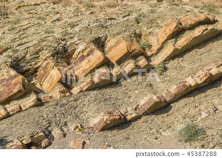 Rock naked breed on a cliff, rocks near the sea. Rock naked breed on a cliff, rocks near the sea. 45387288