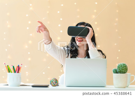 Young woman using a virtual reality headset 45388641