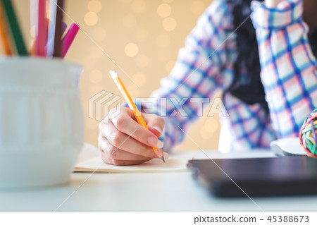 Young woman with notebook and pencil 45388673