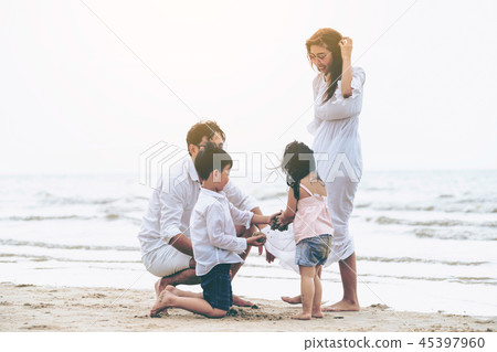 Happy family goes vacation on the beach in summer. 45397960