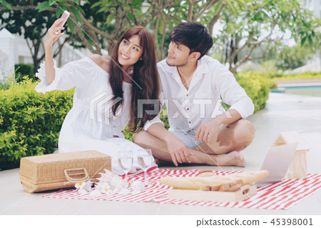 Young couple go picnic at the park in summer. 45398001