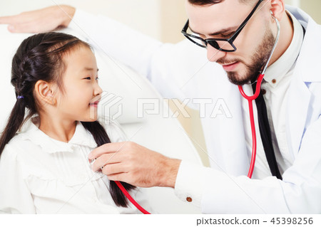 Doctor examining little happy kid in hospital. 45398256