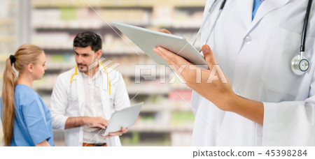 Doctor working in hospital with other doctors. Doctor working in hospital with other doctors. 45398284