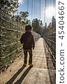 Boy crossing a suspension bridge 45404667