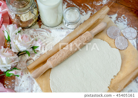 Rolling pin with a pattern on a wooden  table  45405161