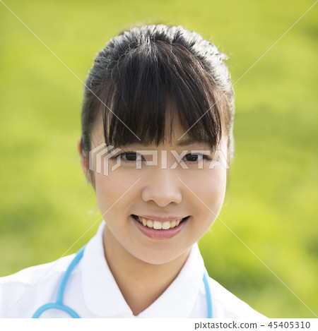 Smiling nurse in the meadow Smiling nurse in the meadow 45405310