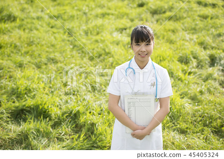 Nurse with medical records in the meadow Nurse with medical records in the meadow 45405324