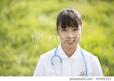 Smiling nurse in the meadow Smiling nurse in the meadow 45405325