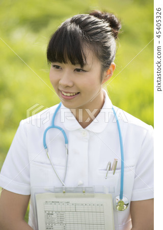 Nurse with medical records in the meadow Nurse with medical records in the meadow 45405326
